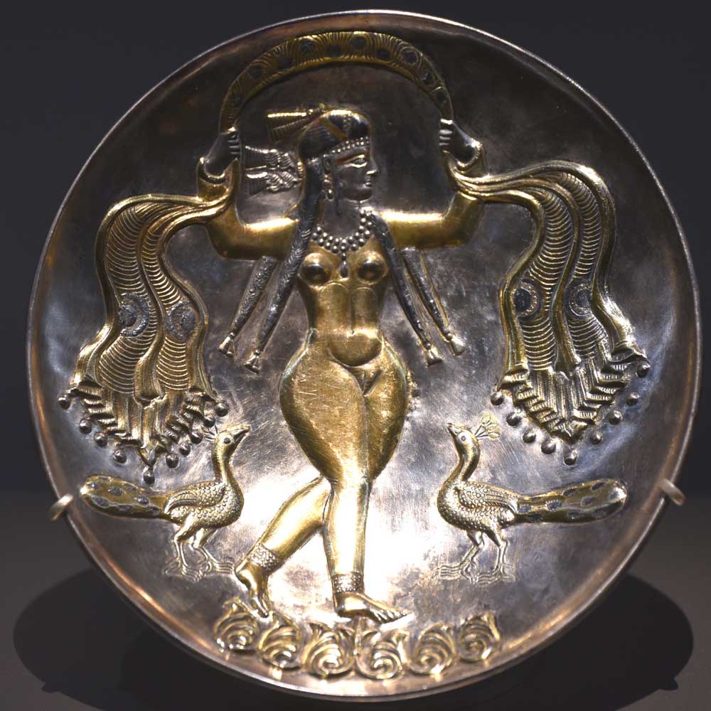Sassanid silver and gold dish from Iran featuring a central female figure, likely Anahita, the Zoroastrian goddess of water, fertility, and health, dating from AD Carole Raddato 400 to 600, Exhibition: Al Thani Collection, Hôtel de la Marine, Paris